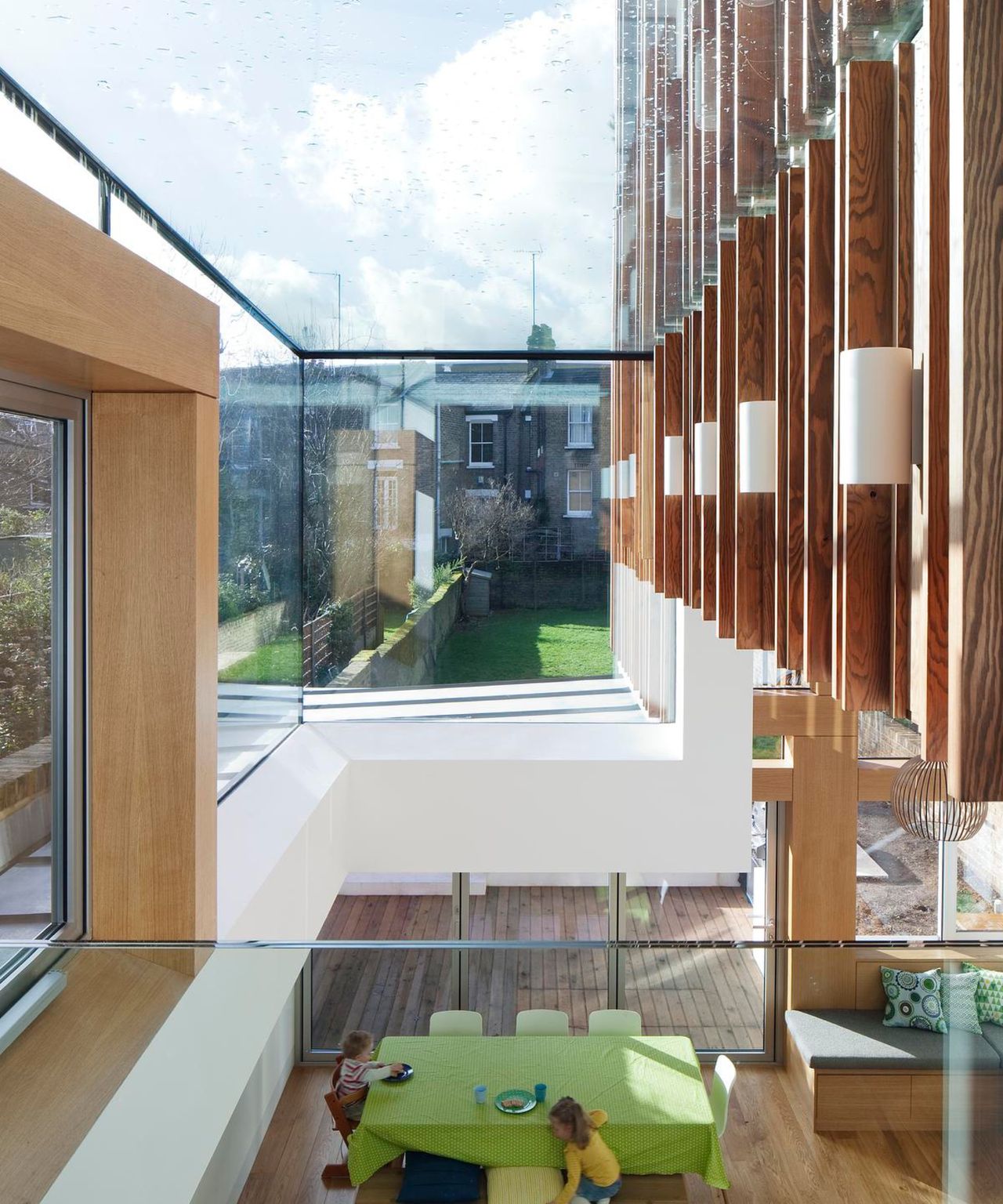 inside of double storey extension with glass roof and timber cladding featuring inside and outside the building