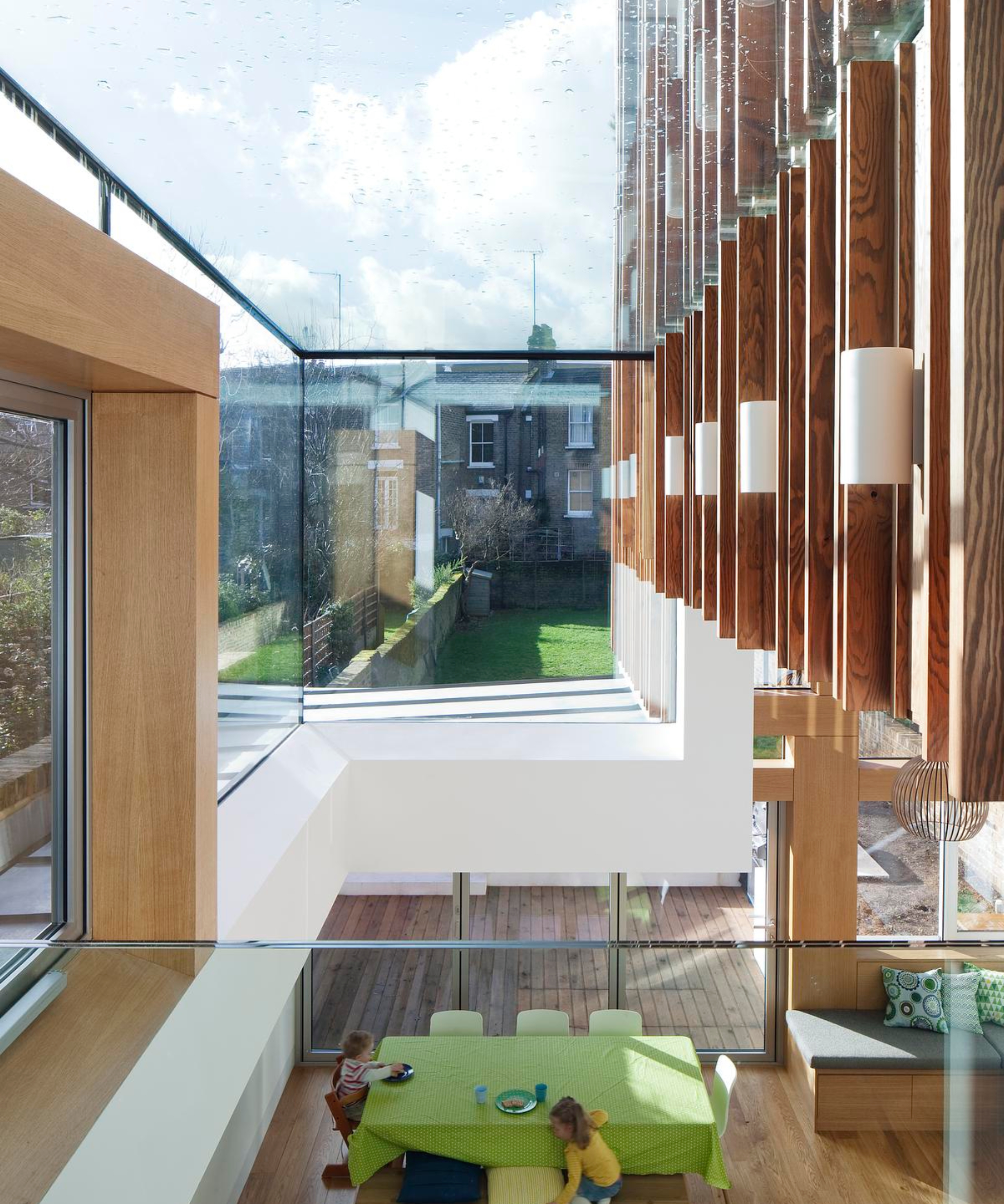 inside of double storey extension with glass roof and timber cladding featuring inside and outside the building