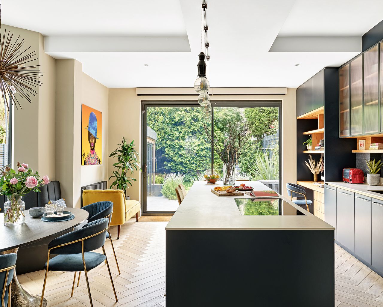 Open plan kitchen with wooden floor and desk area