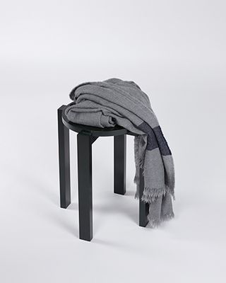 Grey shawl on a small black stool