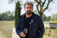 Julien Viaud holding glass of red wine