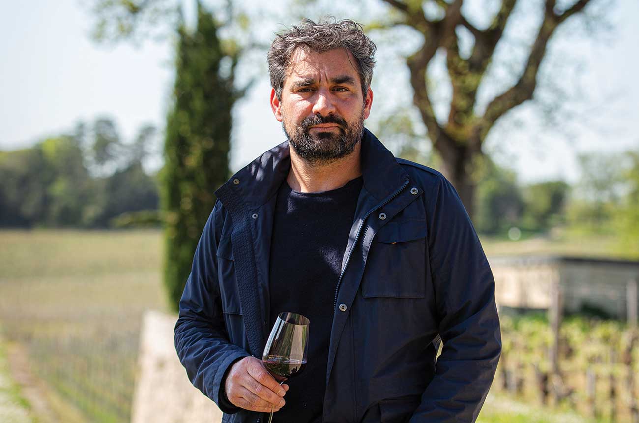 Julien Viaud holding glass of red wine