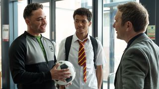 Donte holding a football standing next to Ashton and talking to Jack