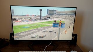 A Philips 27M1F5500P monitor sitting on a wooden desk