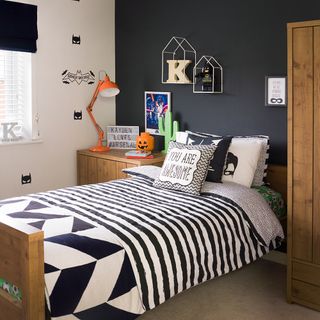 bedroom with dark blue wall and bed