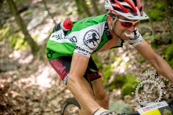 Drew Edsall races toward victory in the NoTubes Trans-Sylvania Epic enduro classification in 2013. In this photo, he demonstrates the technique of holding his timing card between his teeth as he blazes through a timed enduro segment.