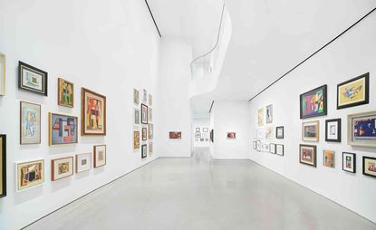 White room with various framed art work on the walls