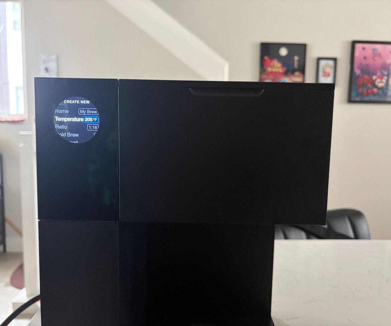 The small LED screen on the top left corner of an Aiden Precision coffee maker.