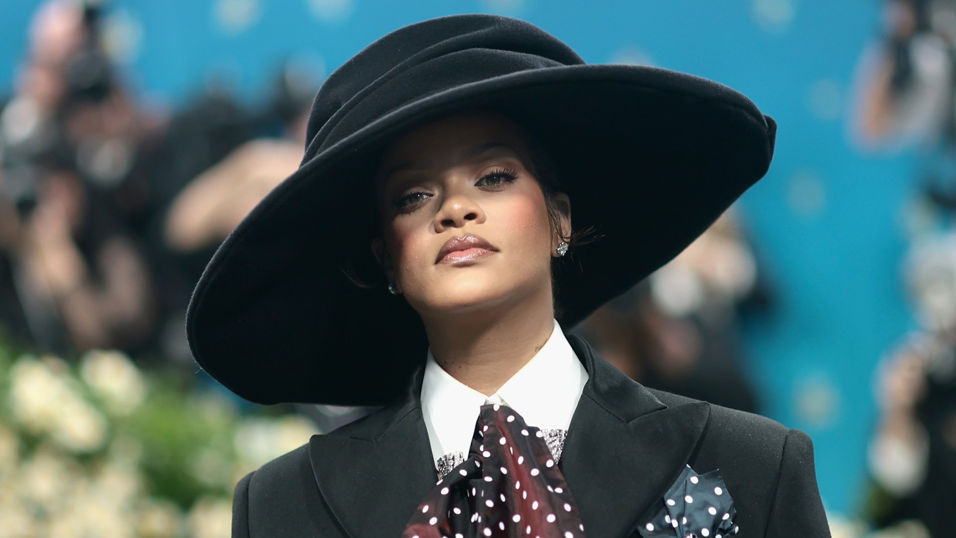 Rihanna wearing a large black top hat at the Met Gala