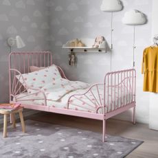 Pink bed frame with heart-patterned bedding