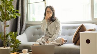 Air purifiers vs humidifers: what's the difference? Image of woman coughing