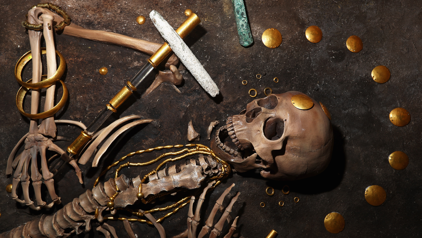 reproduction human skeleton decorated with a variety of gold jewelry and accessories