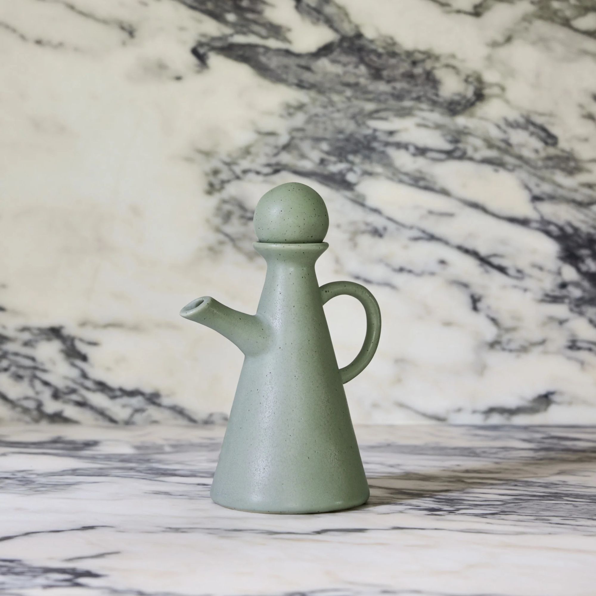 Pale green oil cruet with spherical topper