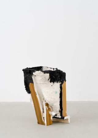 A handcrafted vessel made from a combination of wood and a paper mache and painted white and black.