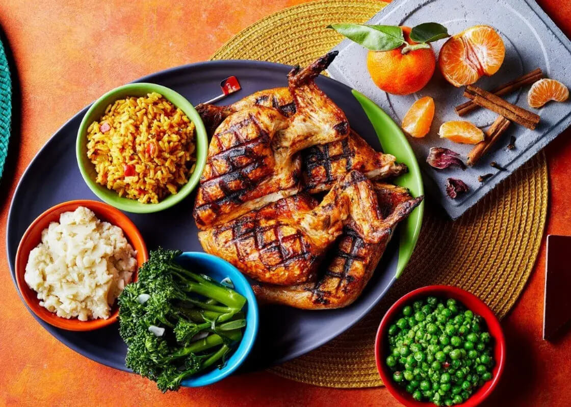 A plate filled with Nando's chicken and sides