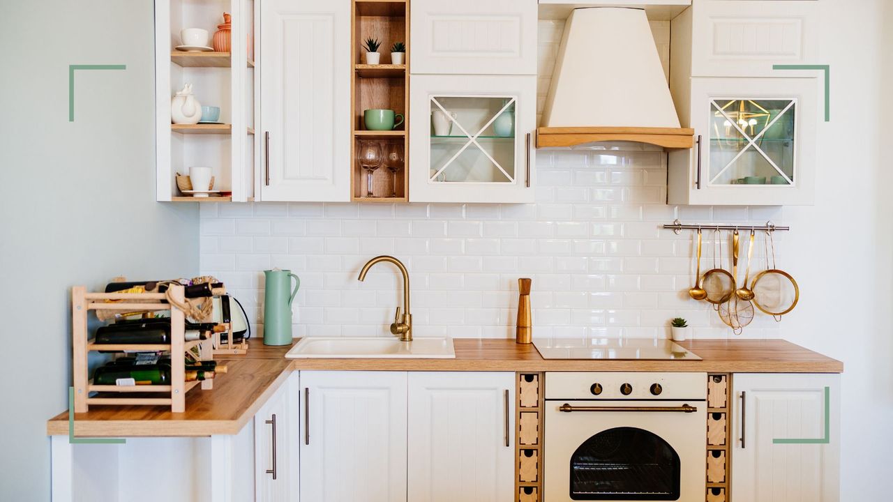 small white kitchen with wooden worktops and smart storage, demonstrating how to organize a small kitchen to maximize countertops and space 