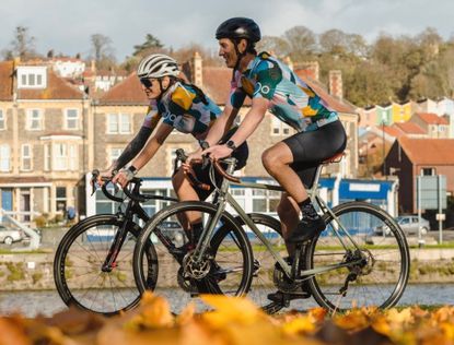 two cyclists riding in sun