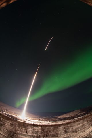 A NASA-funded sounding rocket launches into an aurora in the early morning of March 3, 2014, over Venetie, Alaska. The GREECE mission studies how certain structures — classic curls like swirls of cream in coffee — form in the aurora.