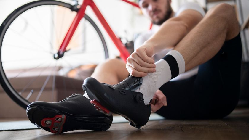 A man putting on shoes for indoor cycling