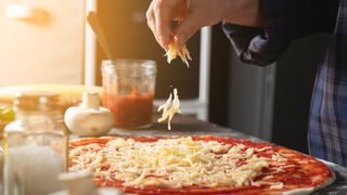 Can you freeze cheese? Image of cheese sprinkling on pizza