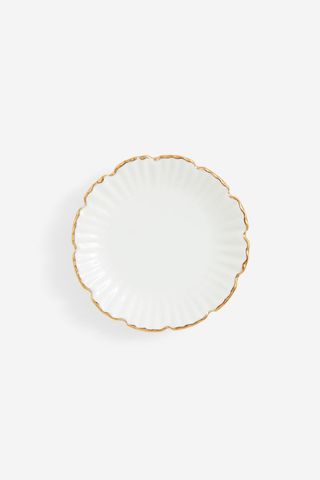 top view of a gold-rimmed round trinket tray