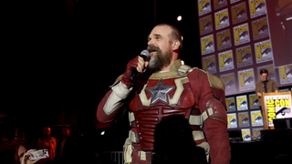 David Harbour dressed as the Red Guardian character with microphone