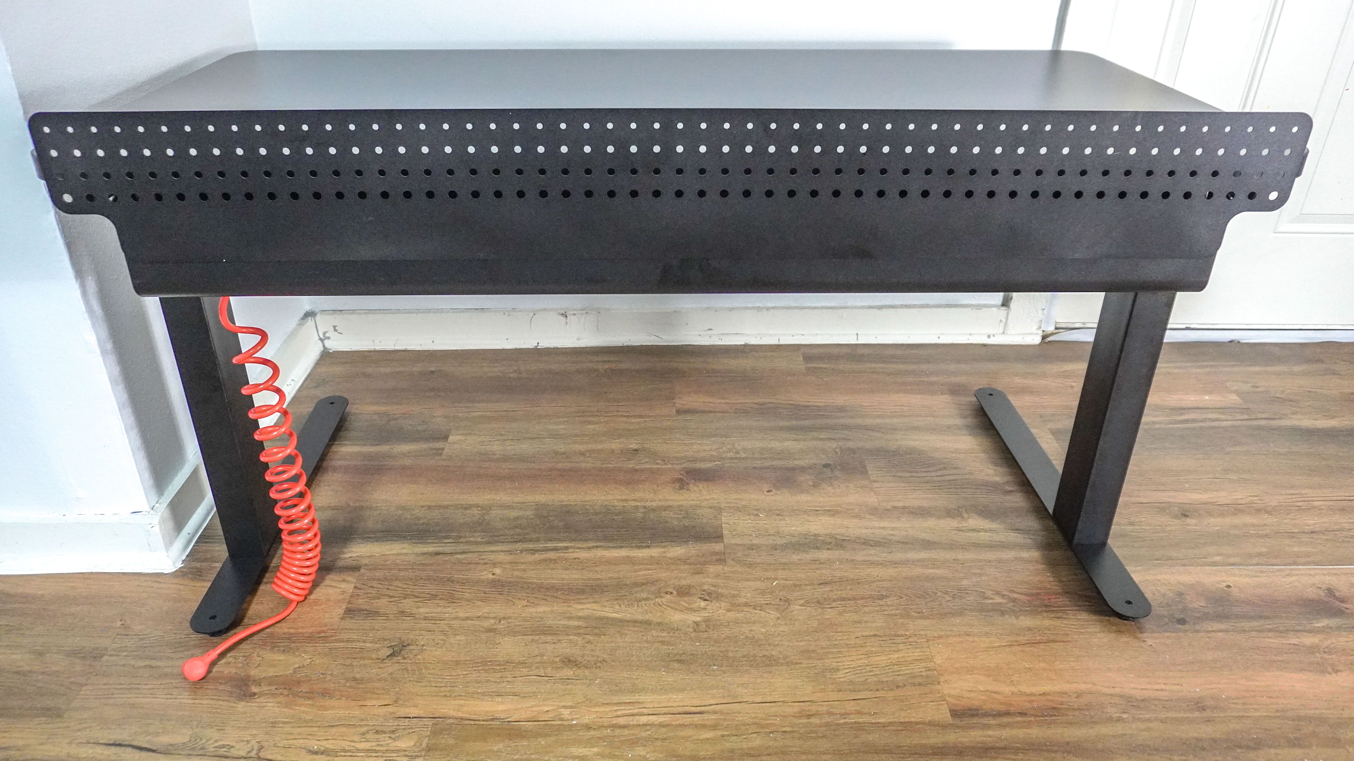 The Herman Miller Coyl Gaming Desk seen from behind showing off its optional metal shroud