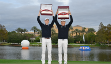 Jason and Bernhard Langer hold the PNC Championship belts above their heads