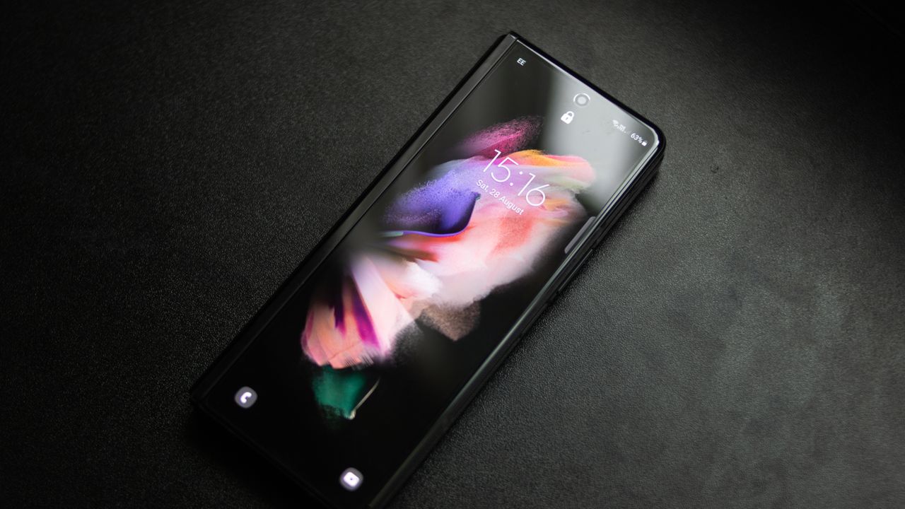 A photograph of the Samsung Galaxy Z Fold 3 folded over and laid on a table