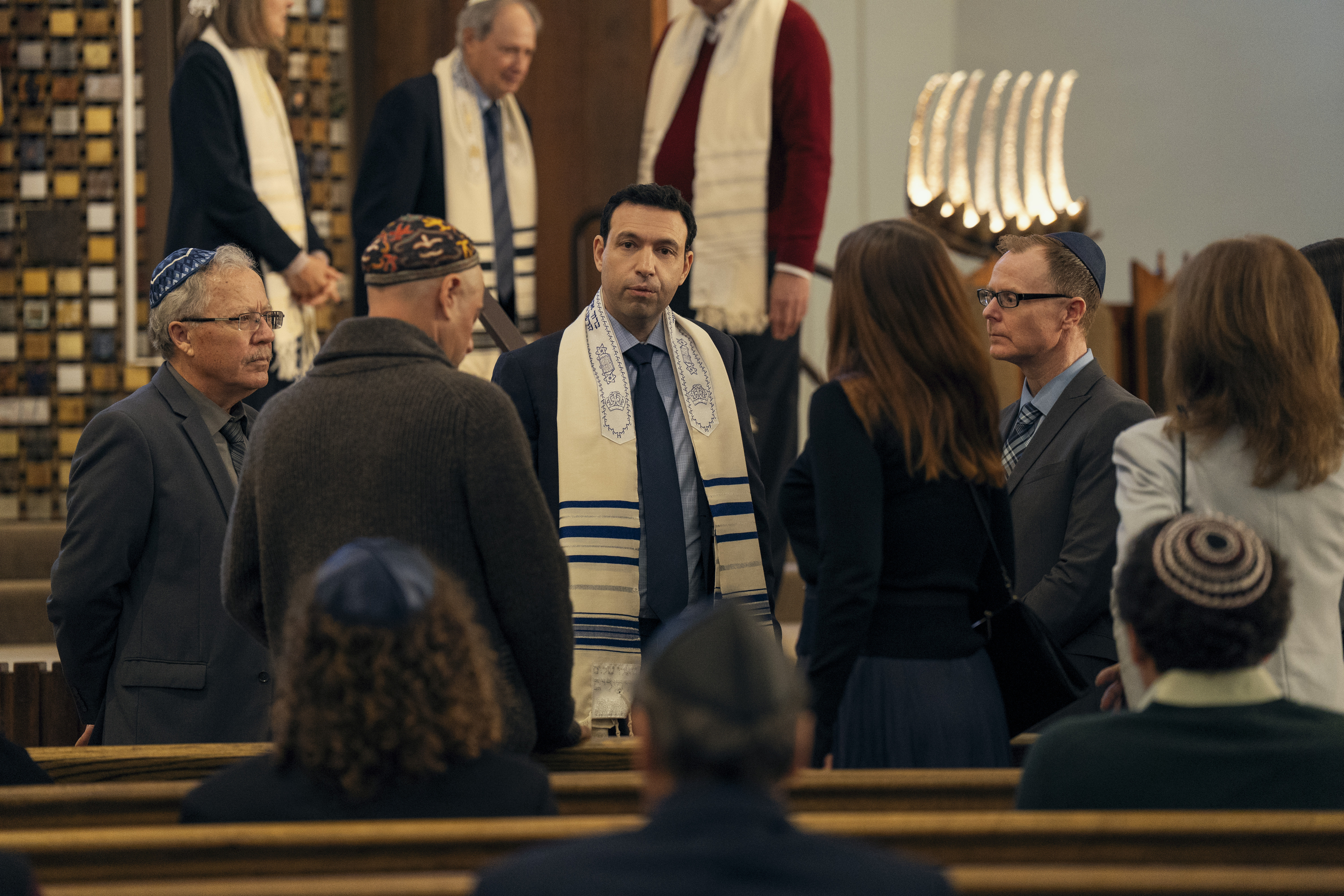 Alex Karpovsky as rabbi big noah at the front of a temple altar after services in nobody wants this season 2