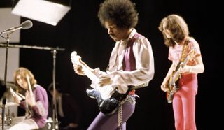 (from left) Mitch Mitchell, Jimi Hendrix, and Noel Redding perform live