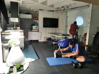 Selene III crewmembers exercise indoors using the stationary bicycle and other available exercise equipment at HI-SEAS.