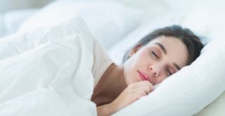 Woman sleeping on one side of the bed