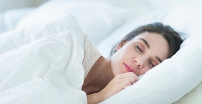 Woman sleeping on one side of the bed