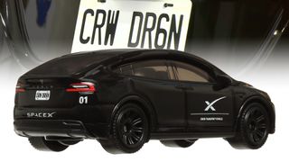 photo of a black car with a white "X" on its side. Superimposed above it is a closeup of its license plate, which reads "CRW DR6N"