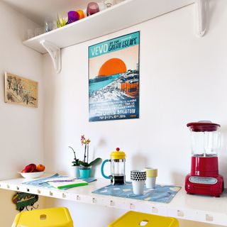 Fitted white breakfast bar, yellow stools, red blender vintage artwork