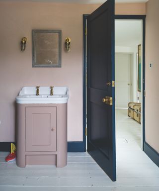colors not to paint your furniture, pale pink bathroom with matching vanity unit, white floor, navy door and matching woodwork