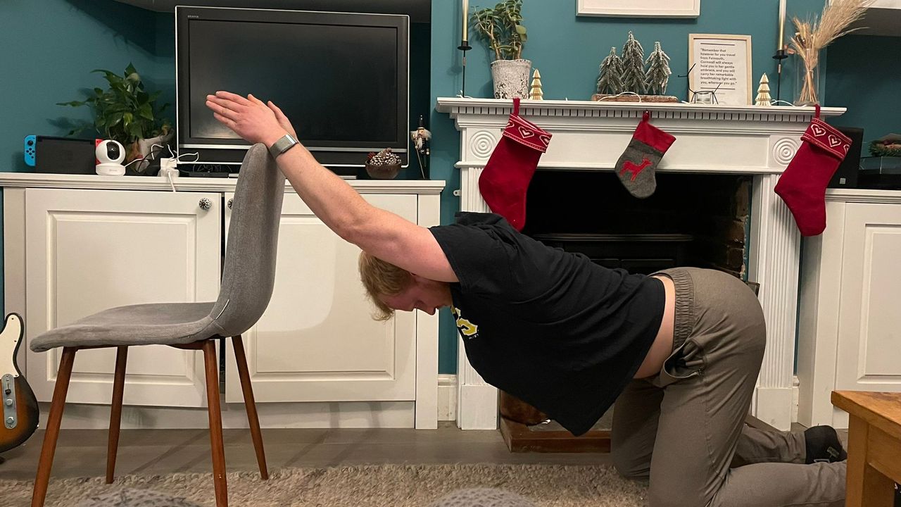 Fit&amp;Well fitness writer Harry Bullmore performing a kneeling thoracic extension