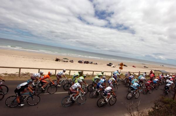 The peloton speed along the beach front at the Tour Down Under
