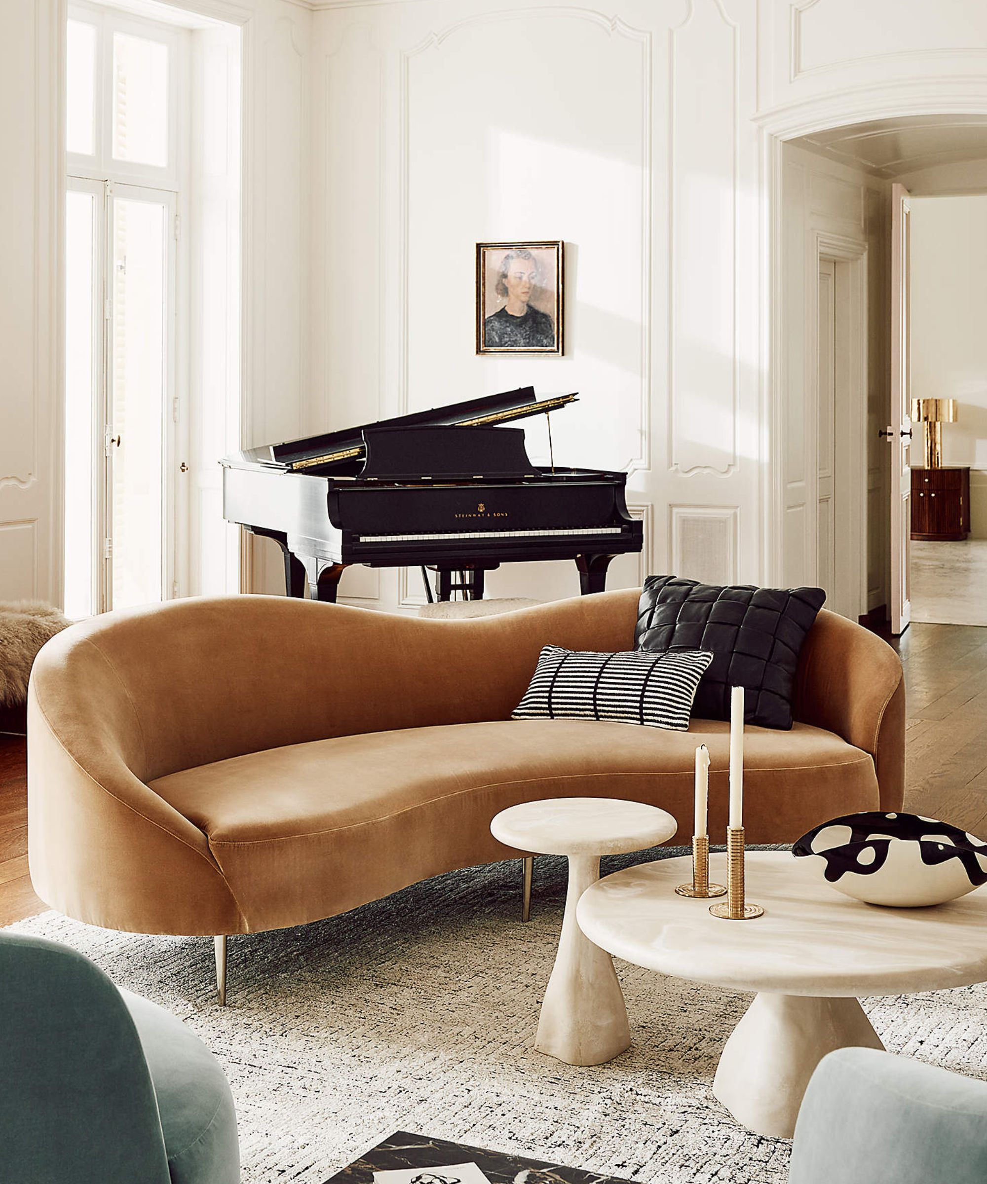 neutral traditional living room with panelled walls, and a camel velvet curved couch