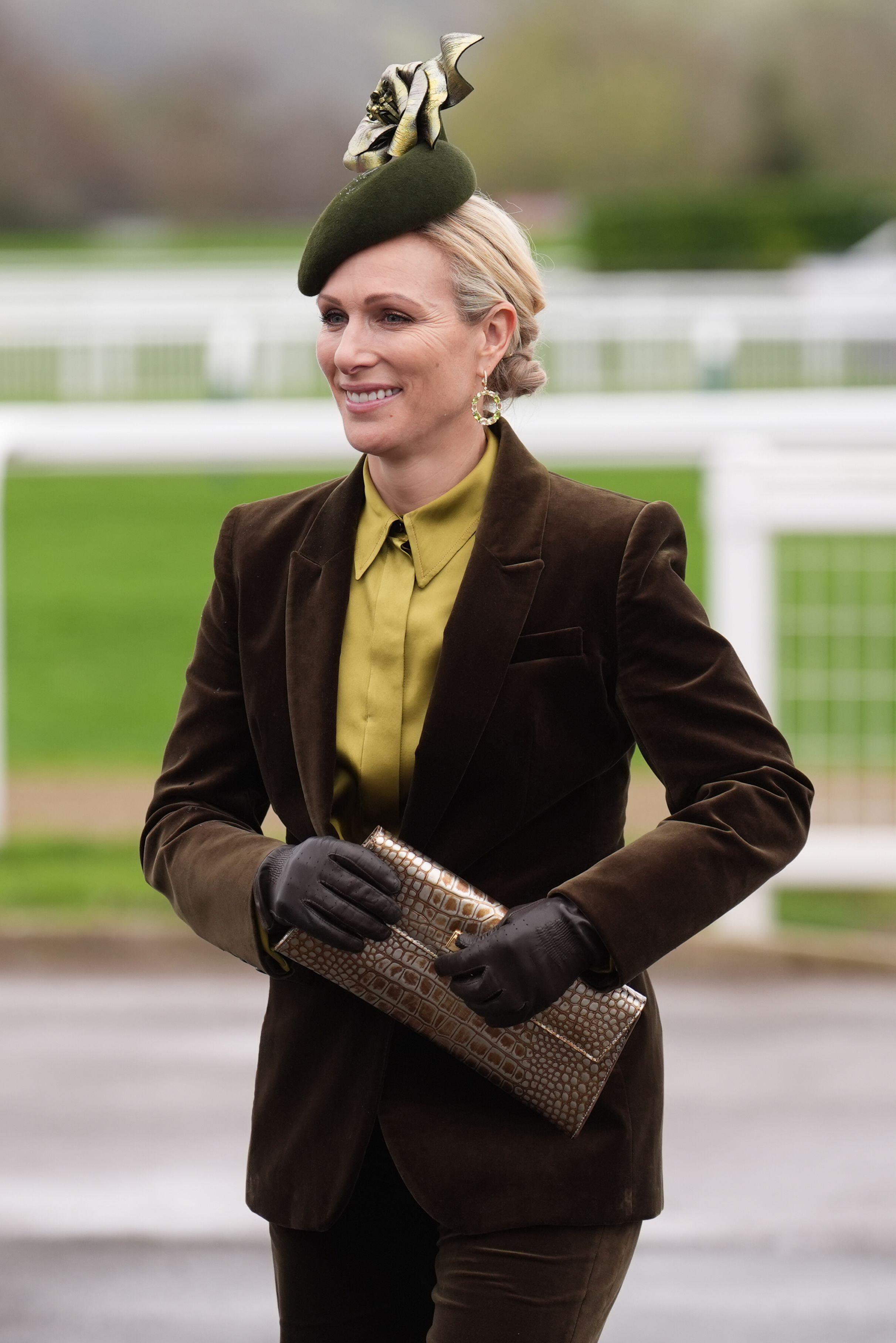 Zara Tindall in a suit and green hat at Cheltenham