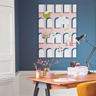 study room with navy blue wall and crane lamp
