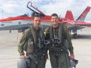 Canadian Space Agency astronauts Joshua Kutryk (left) and Jeremy Hansen, both pilots with the Royal Canadian Air Force, in front of the 2017 Canada 150 CF-18 Demonstration Hornet.