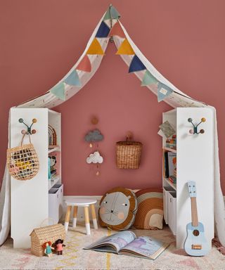 Billy bookcases facing each other to make a reading den in a kids room with fabric canopy over the top