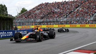 Max Verstappen taking a corner with Lewis Hamilton following closely behind