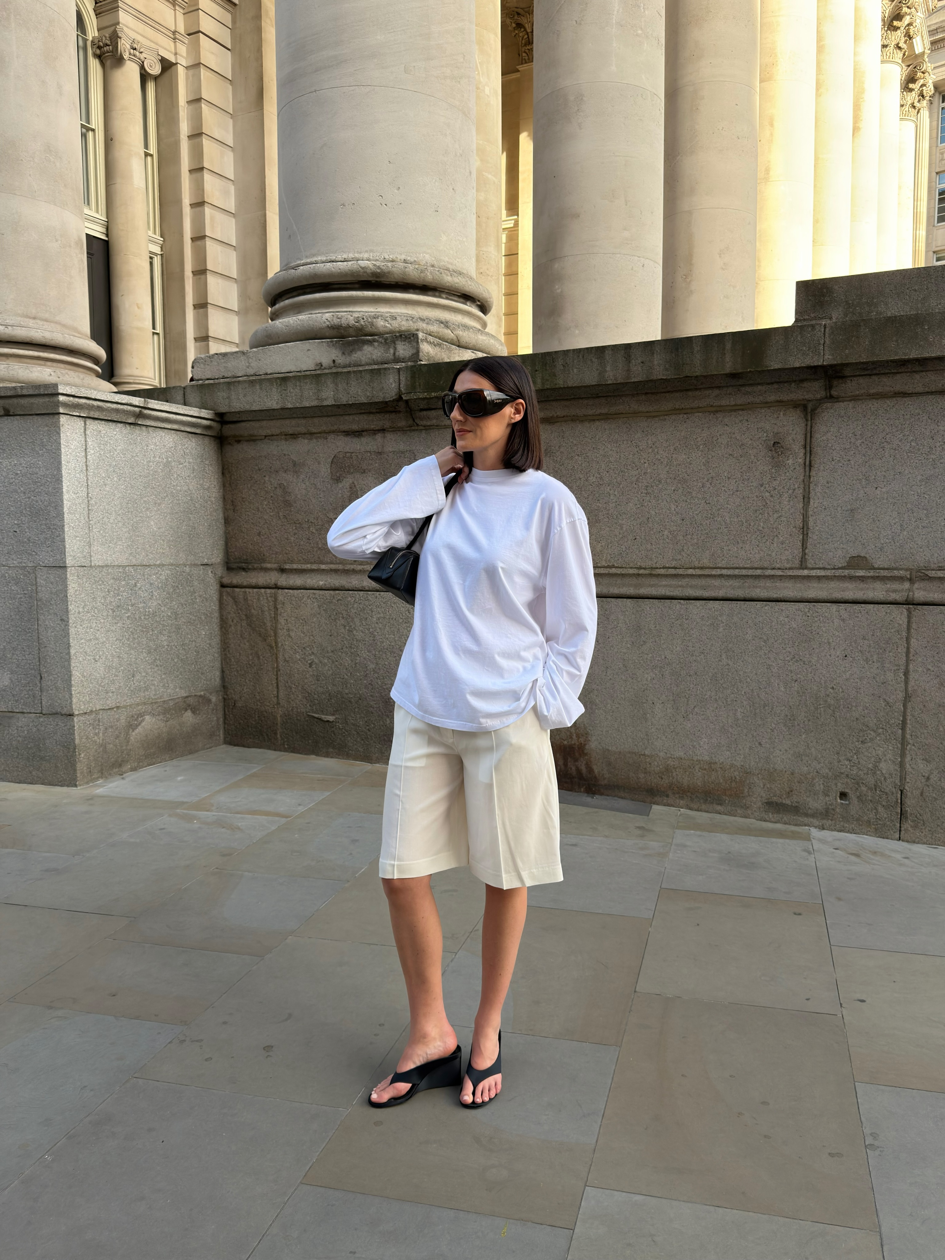 An image of a woman wearing skinny wedge sandals