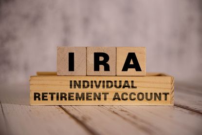 Light wooden blocks and cubes with the text IRA Individual Retirement Account