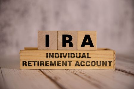 Light wooden blocks and cubes with the text IRA Individual Retirement Account