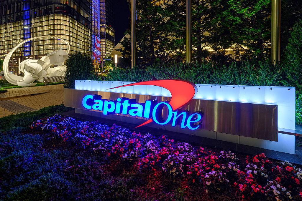 The Capital One logo is lit up outside of the financial services company headquarters building at night on June 7, 2025, in Tysons, VA.