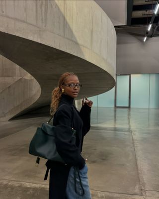 Justine Skye wearing a black turtleneck sweater.